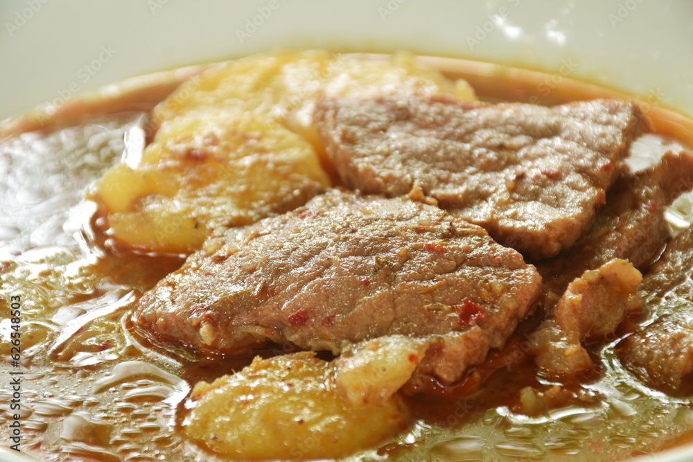 beef curry or Mussamun Indian food with slice potato on plate beef curry or Mussamun Indian food with slice potato on plate