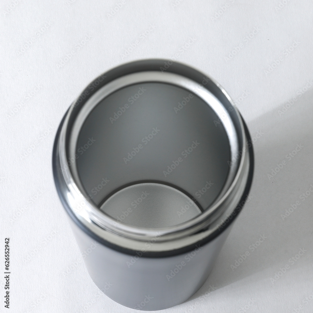 metal thermal bottle for water on a pastel background. Stainless Steel Vacuum Insulated thermos Bottle, Hero product shot of stainless steel reusable insulated beverage container metal thermal bottle for water on a pastel background. Stainless Steel Vacuum Insulated thermos Bottle, Hero product shot of stainless steel reusable insulated beverage container