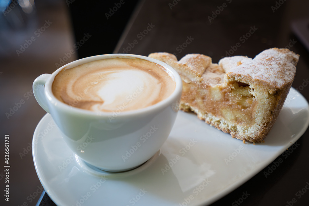 Piece of an apple pie and cup of coffee espresso on wooden table. Shallow focus Piece of an apple pie and cup of coffee espresso on wooden table. Shallow focus