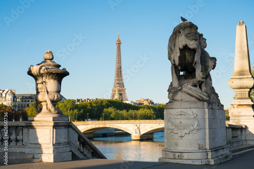 View of Eiffel Tower from Pont Alexandre III bridge in morning sunlight. Eiffel Tower is one of the most iconic landmarks of Paris