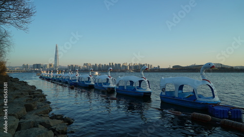 Photography Duck boats lined up along the river in the evening, Seoul