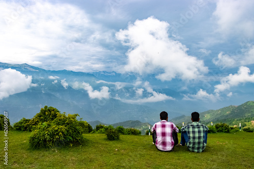 people relaxing at top peak oh himalyan mountain having a beautiful scenic landscape view photo