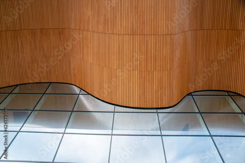 part of a modern building in Norway, with floating wooden structure and large glass windows