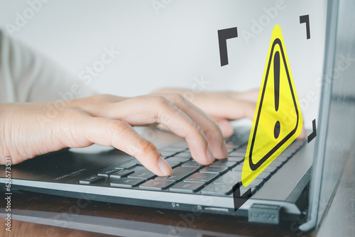 Fototapeta Naklejka Na Ścianę i Meble -  Digital Crime,Cyber Security, information security,data protection concept.,Woman using laptop with yellow triangle warning sign perfect for technology,Encrypted privacy idea.