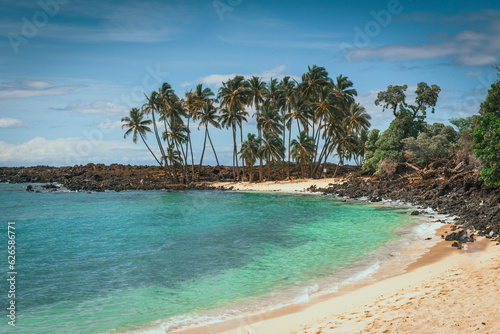 Mahaiula beach with palm trees and lava rocks