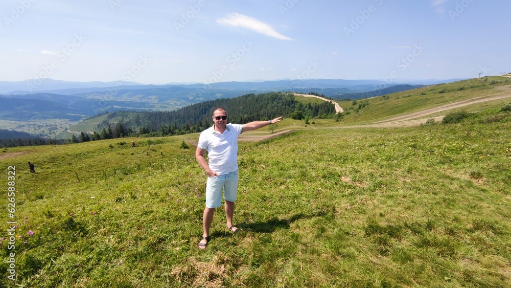 young man on the background of mountains in summer. Carpathians Ukraine