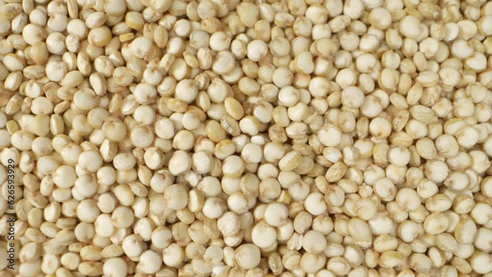 White quinoa showcases a light ivory to pale yellow color, distinguishing it from other quinoa varieties with darker hues, such as red or black quinoa. Macro video. Food concept. Quinoa background
White quinoa showcases a light ivory to pale yellow color, distinguishing it from other quinoa varieties with darker hues, such as red or black quinoa. Macro video. Food concept. Quinoa background