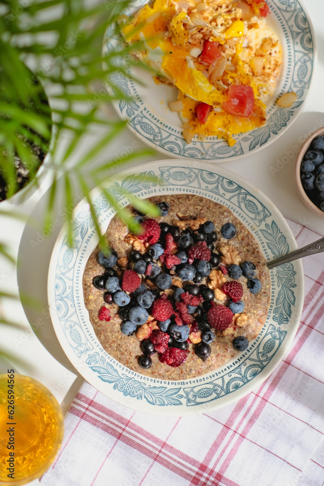 Healthy vitaminrich balanced vegan breakfast. Raw flaxseed porridge with walnuts, berries