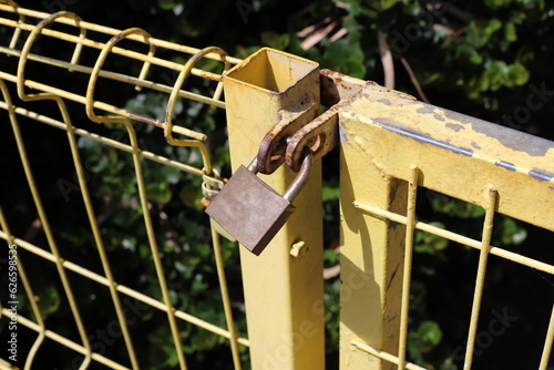 An old padlock hangs on the gate.