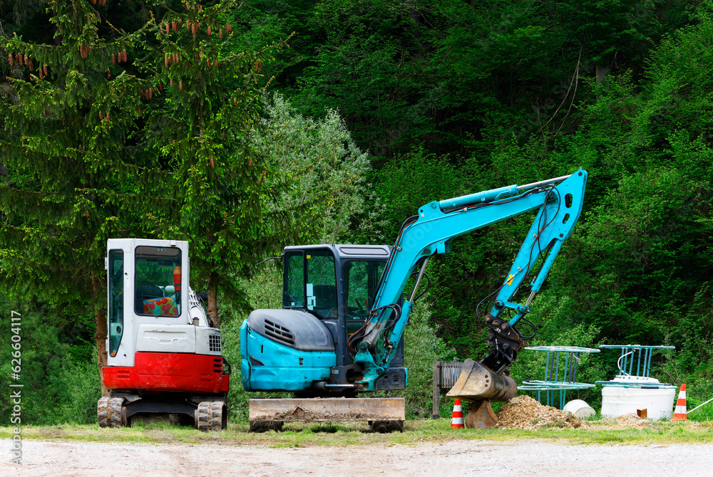 Mini excavator at the construction site. Compact construction equipment for earthworks. An indispensable assistant for earthworks