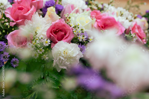 Creative layout made of colorful flowers and leaves for decoration at wedding.Roses in a mixed flower bouquet on vintage style.Floral background. © arcyto
