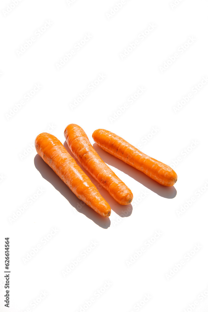 Fresh carrots on a white background. Top view, flat lay Fresh carrots on a white background. Top view, flat lay
