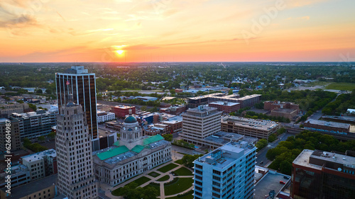 Horizontal aerial panorama golden sunrise over downtown Fort Wayne with focus on courthouse