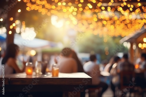 Street cafe, restaurant, evening. Illumination bokeh and defocused people sit at tables.