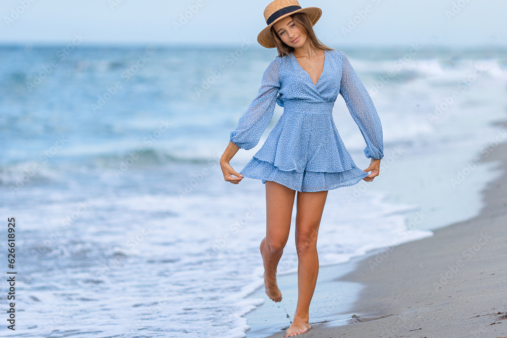 Beautiful teenager girl on tropical seashore walking at shallow water and having fun Beautiful teenager girl on tropical seashore walking at shallow water and having fun