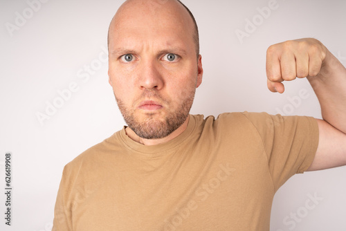 Young man looks agressive and fists his hand