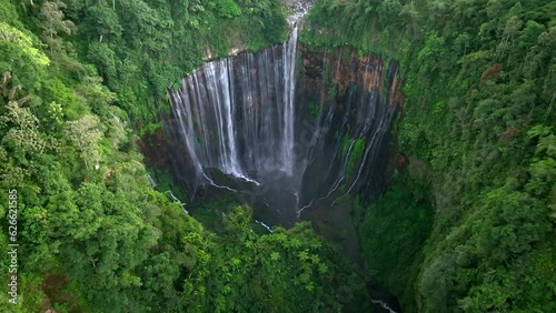 Aerial view from drone of Tumpak Sewu waterfall, falls flow into steep canyon, Malang, East Java, Indonesia
