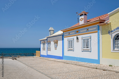 Beautiful buildings in Ericeira, Portugal, on a sunny day, with the sea in the background