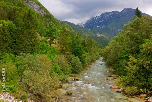 Majestic turquoise Soca river in the green forest, Bovec, Slovenia, Europe. Beautiful rafting and kayaking place in Europe. Great recreation place and kayaking destination. 