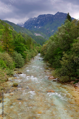Majestic turquoise Soca river in the green forest, Bovec, Slovenia, Europe. Beautiful rafting and kayaking place in Europe. Great recreation place and kayaking destination. 