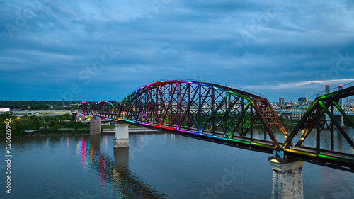 Rainbow pride illuminated bridge at night aerial over Ohio River Kentucky