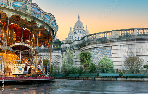 Vintage carousel and the Basilica of the Sacred Heart in Montmartre, Paris France photo