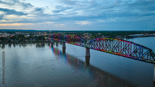 Silver blue sunset over arch bridge aerial rainbow pride illuminated at night over Ohio River
