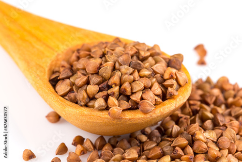 Uncooked buckwheat on wooden spoon © romantsubin