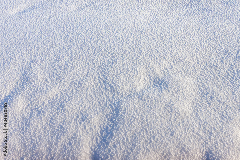Texture of white snow with blue shadows