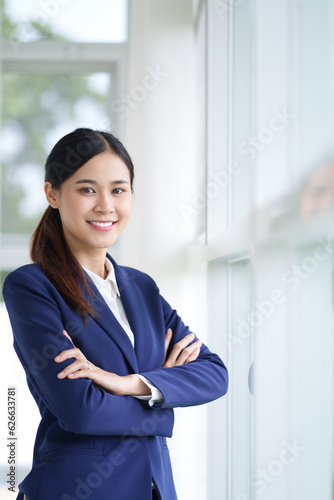 Portrait of Confident happy female employee in modern office, smile with positive mindset..