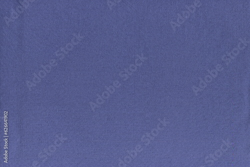 The texture of a soft natural cotton fabric of blue color in . Soft knitted napkin. home textiles. Dust rag. The usual simple background of pure natural fabric.