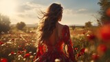 Young woman in dress enjoying summer freedom, walking in flower meadow at sunset, country sunshine, beauty of countryside