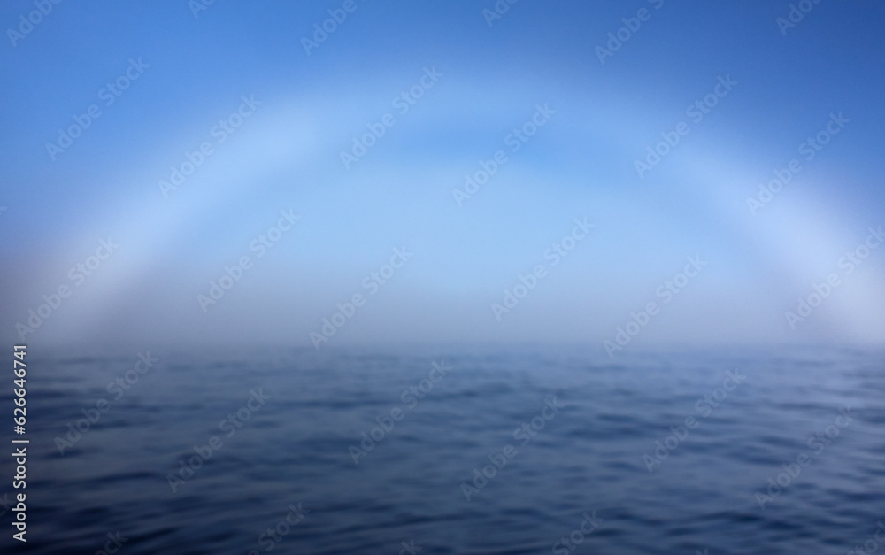 A fogbow over Arctic Ocean near North Cape in Northern Norway on late summer day in August 2022. A fogbow over Arctic Ocean near North Cape in Northern Norway on late summer day in August 2022.