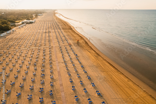 Morning on the still deserted beach. Umbrella beach for relaxing and sun set beach. Bibione, Italy
