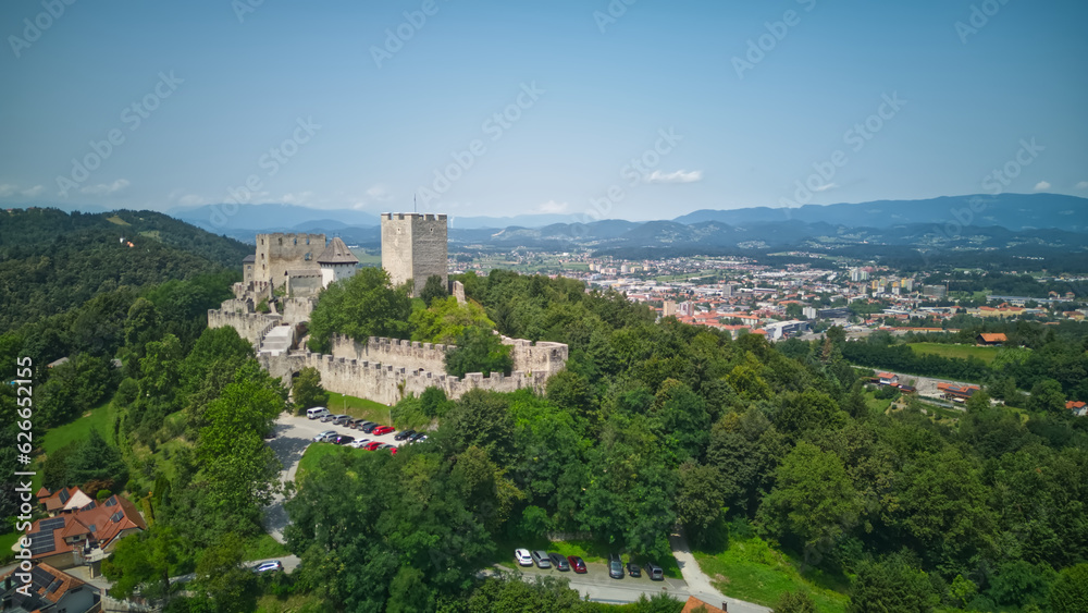 Fototapeta premium Celje Old castle (Celjski Stari grad), aerial view of medieval fortification and town of Celje in Lasko valley in Julian Alps mountains, Slovenia, Styria.