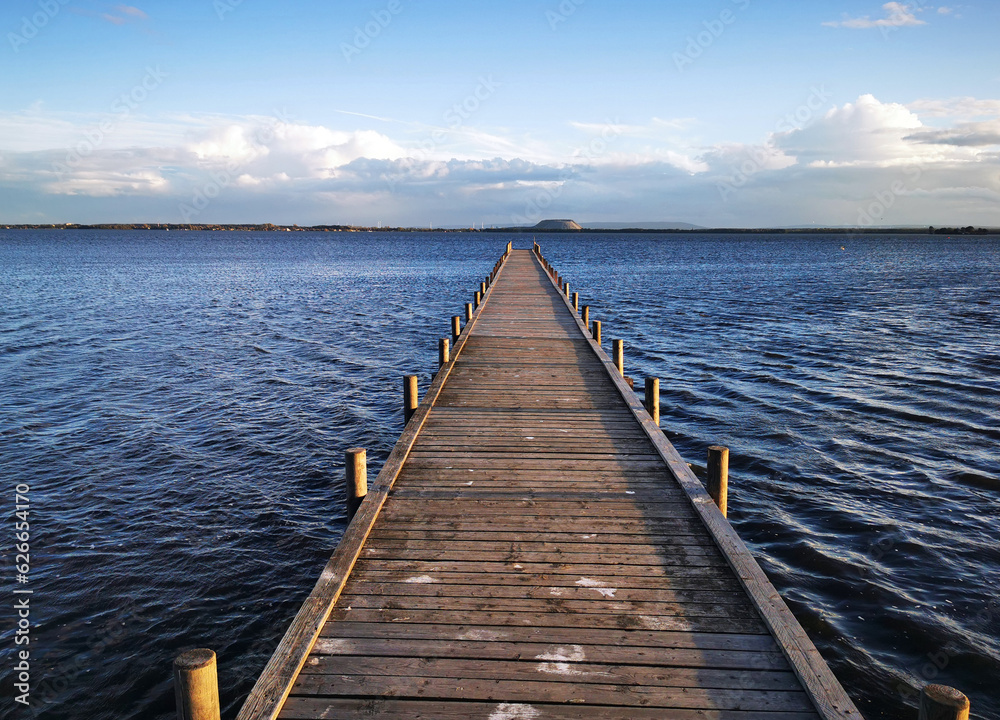 View of jetty in reeds in great evening atmosphere View of jetty in reeds in great evening atmosphere