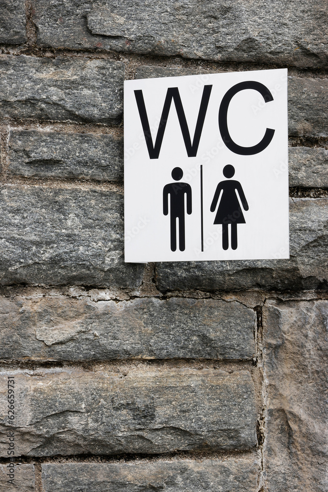 Female / Male restroom. Sex symbol on red brick wall and white brick as background. Toilet icon, Restroom Concept Female / Male restroom. Sex symbol on red brick wall and white brick as background. Toilet icon, Restroom Concept