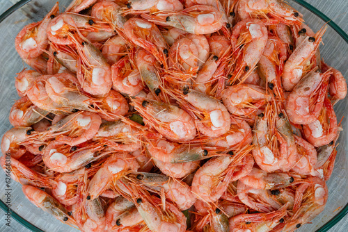 Close up on boiled big sea prawns or shrimps on glass plate. seafood, dieting food. Seafood on the counter. Photo of shrimp in the supermarket. Wholesale of fish. Frozen shrimp
