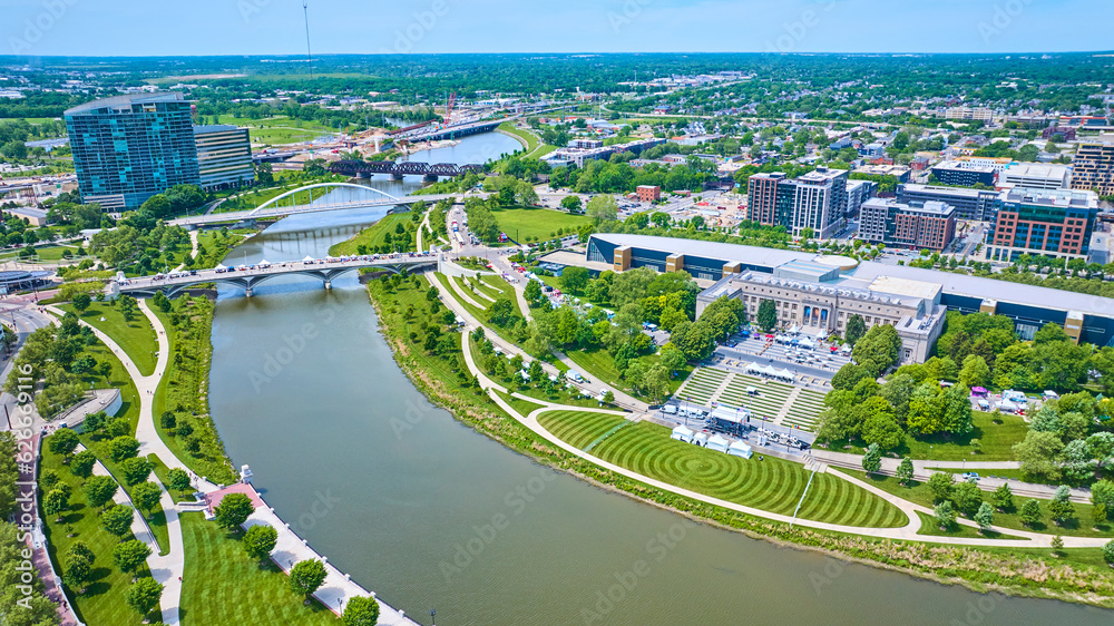 Aerial Scioto Mile Greenway and promenade with winding river leading out of Columbus city
