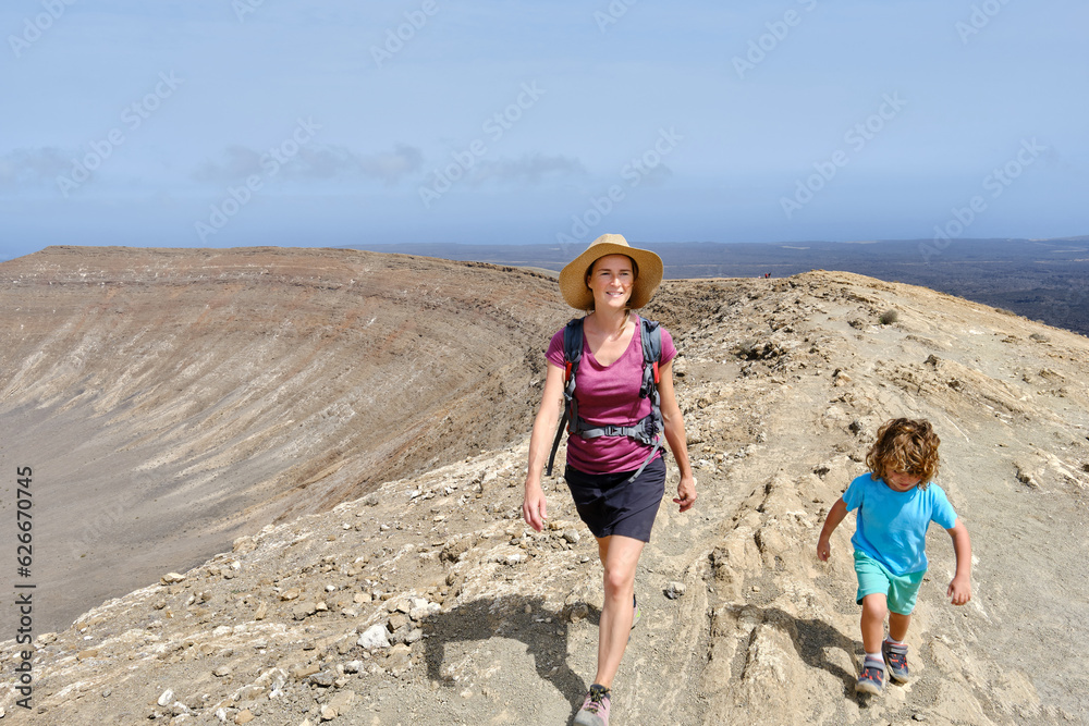 Traveling woman with son walking on top of mountain Traveling woman with son walking on top of mountain