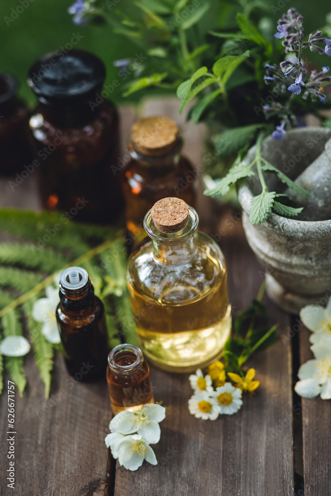 Assortment of pure organic natural essential aroma oil with mint , camomile on wooden background. Concept of herbal, floral ingredients in cosmetology. Alternative medicine, therapy, Ayurveda Assortment of pure organic natural essential aroma oil with mint , camomile on wooden background. Concept of herbal, floral ingredients in cosmetology. Alternative medicine, therapy, Ayurveda