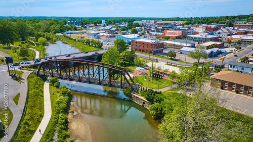 Aerial of metal walking bridge with view of city of Mount Vernon Ohio