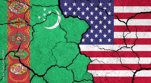 Flags of Turkmenistan and USA on cracked surface - politics, relationship concept