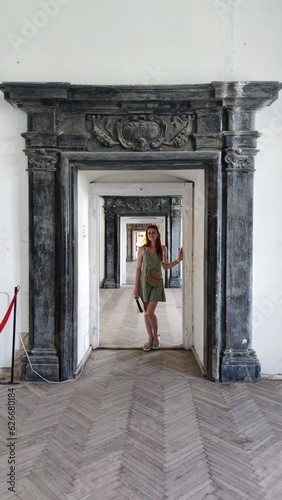 woman in the arch of the door of the great hall of the ancient palace. old castle Podgortsy, Lviv region, Ukraine. photo