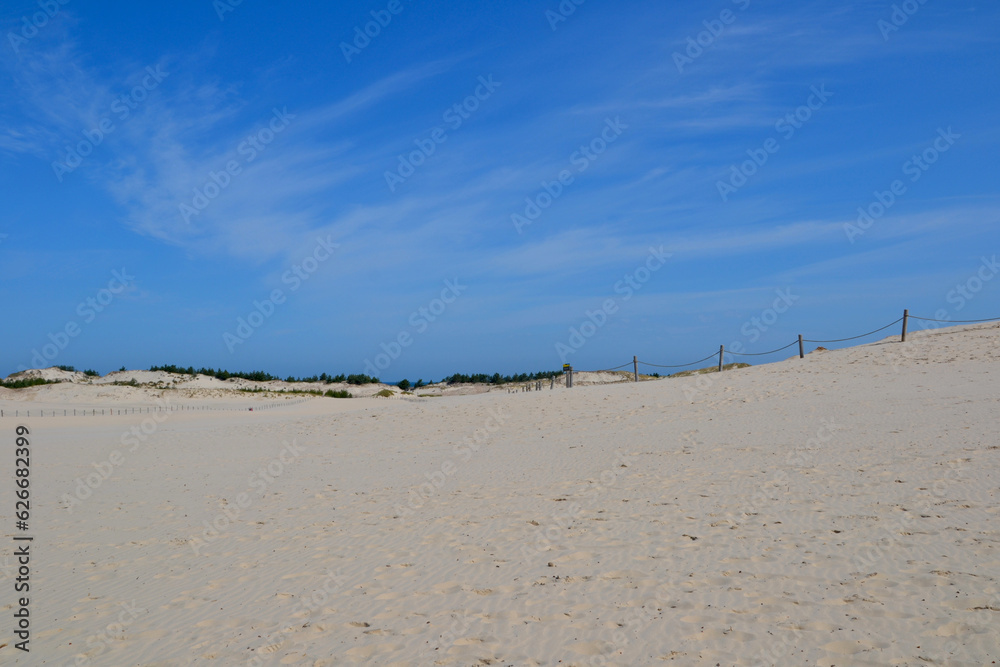 Moving dunes in the Slovincian National Park also known as Slowinski National Park. Landscape with beautiful sand dunes and blue sky by the Baltic Sea, Leba. Poland