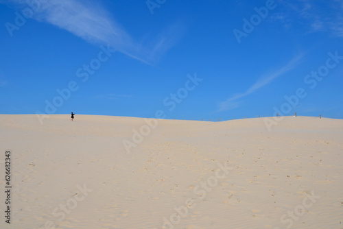 Moving dunes in the Slovincian National Park also known as Slowinski National Park. Unidentified person explore sand dunes by the Baltic Sea, Leba. Poland