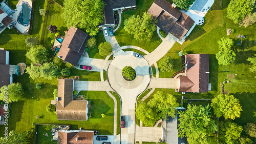 Roof view of cul-de-sac houses in low to middleclass neighborhood with landscaping aerial