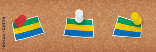 Gabon flag pinned in cork board, three versions of Gabon flag.