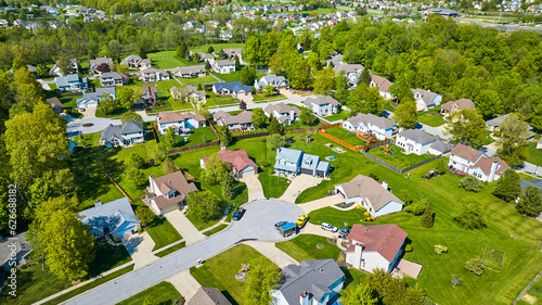 Aerial homes with fences in suburban neighborhood clean houses and lawns