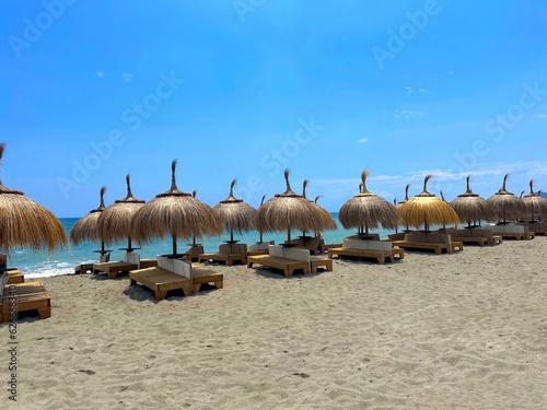 Umbrellas and sunbeds on a sandy beach in Spain, vacation, recreation, tourism